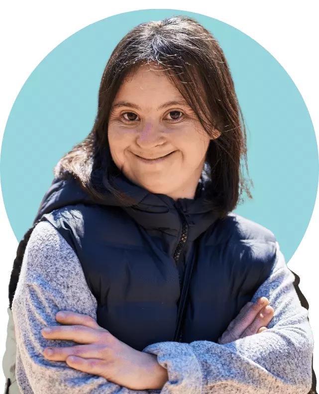 Happy girl with down syndrome smiling at camera